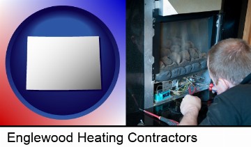 a heating contractor servicing a gas fireplace in Englewood, CO