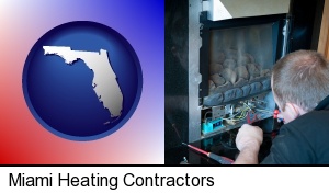 Miami, Florida - a heating contractor servicing a gas fireplace