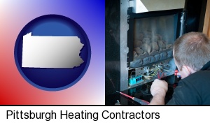 Pittsburgh, Pennsylvania - a heating contractor servicing a gas fireplace