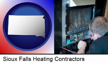a heating contractor servicing a gas fireplace in Sioux Falls, SD