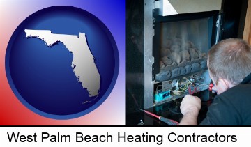 a heating contractor servicing a gas fireplace in West Palm Beach, FL