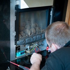 a heating contractor servicing a gas fireplace