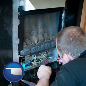 a heating contractor servicing a gas fireplace - with Oklahoma icon