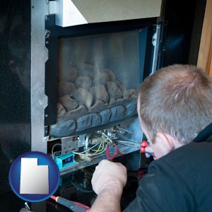 a heating contractor servicing a gas fireplace - with Utah icon