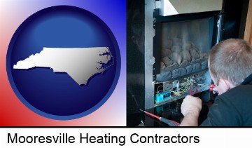 a heating contractor servicing a gas fireplace in Mooresville, NC